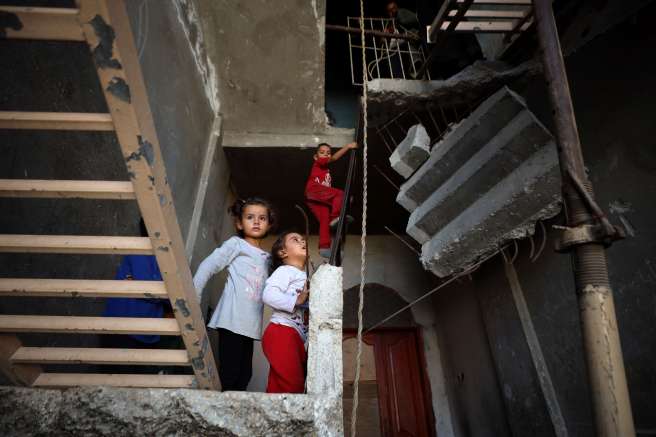 Children pictured inside damaged house