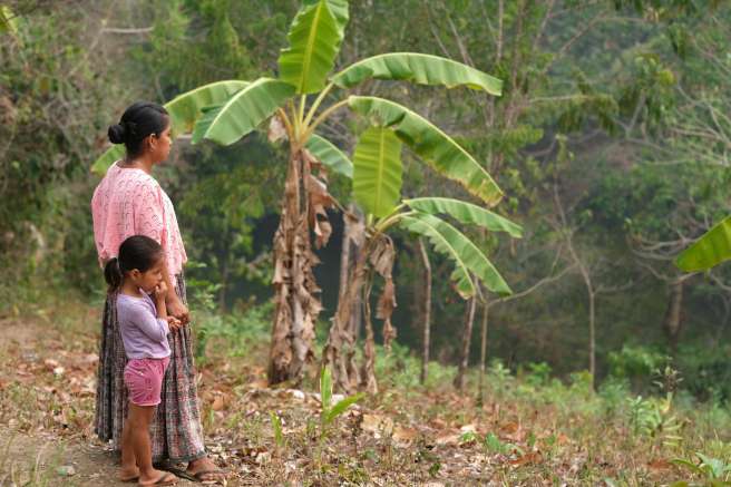 Amelia stands with daughter in plantations in Guatamala