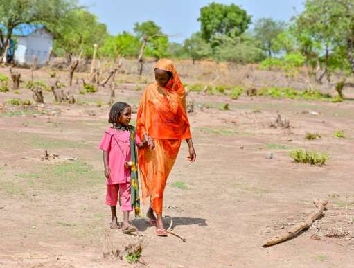 Grandmother and granddaughter walking South Sudan